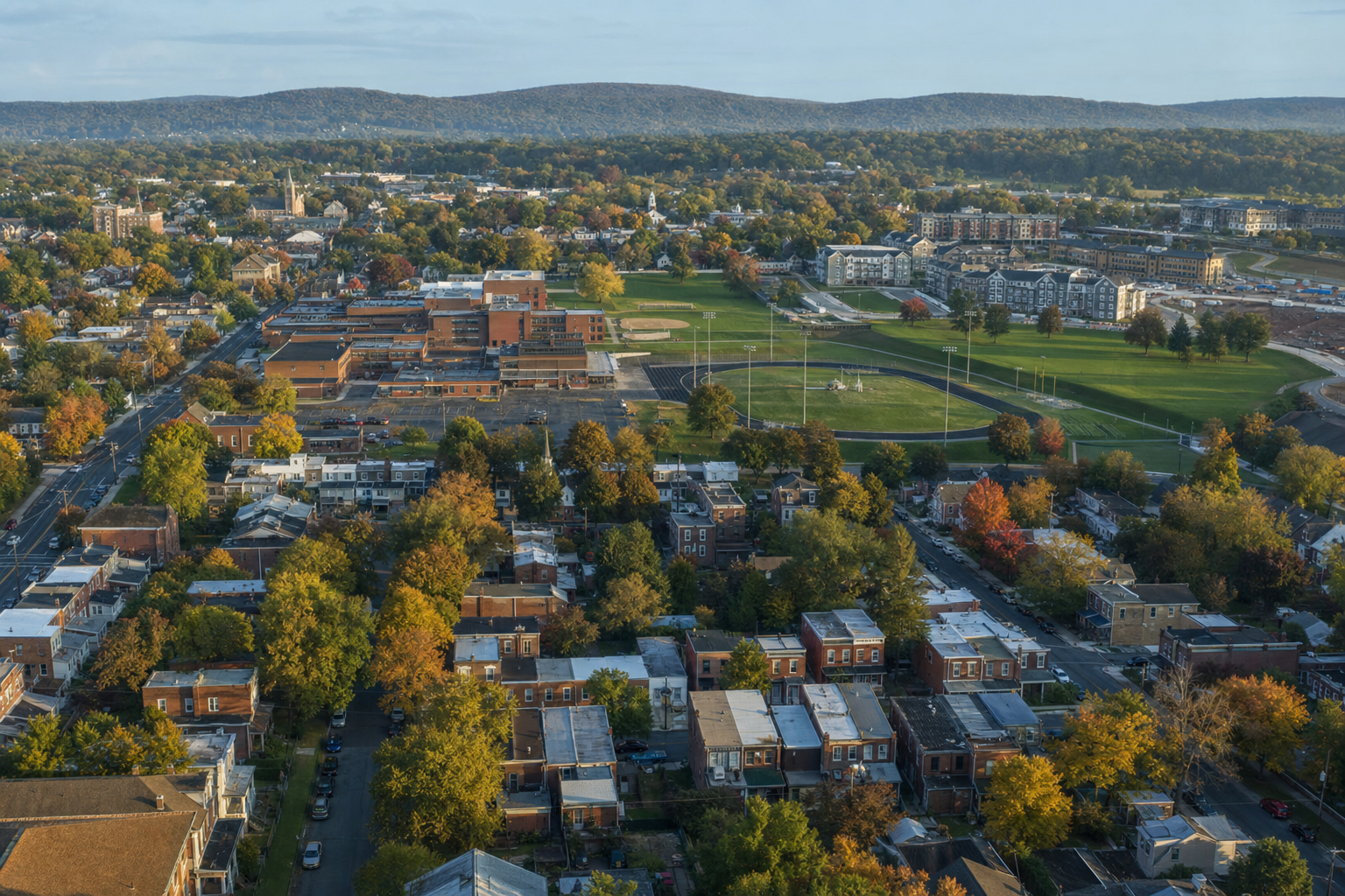 Aerial view of a Pennsylvania borough with tree-lined streets and a school campus